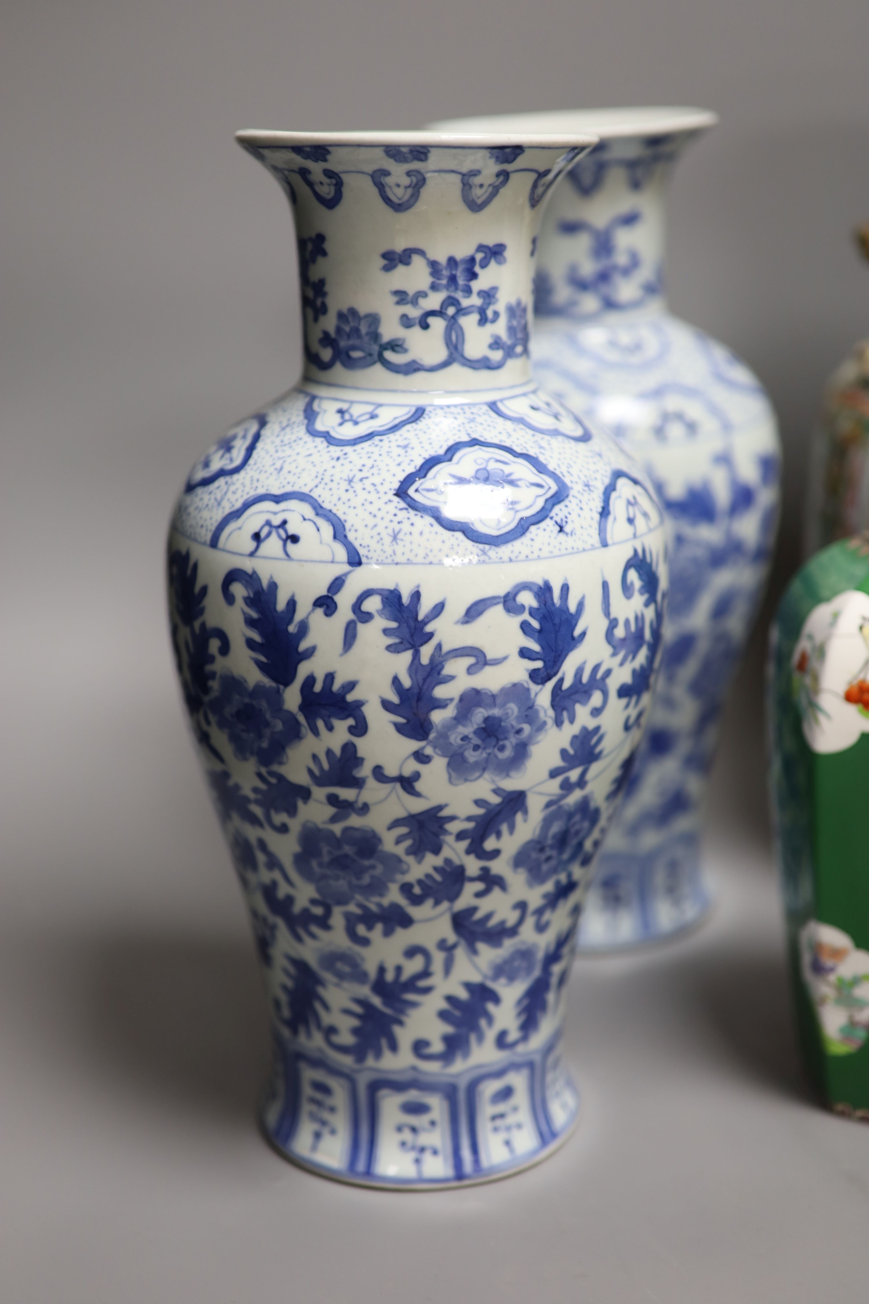 A Chinese famille rose Canton vase, a pair of blue and white vases and two others, tallest 35.5cm